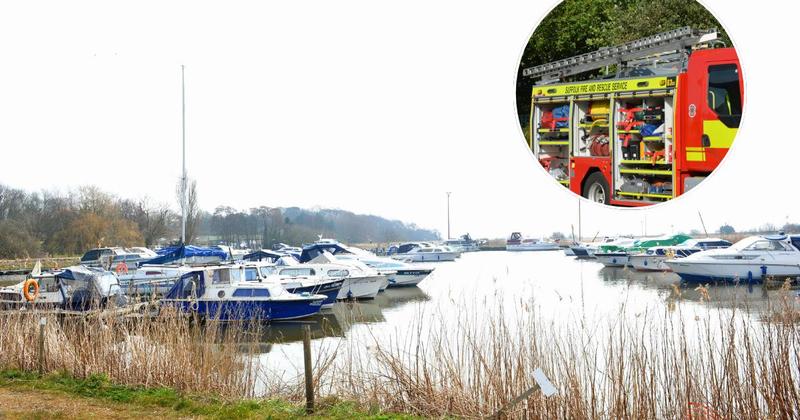 Fire service rescue children and adults stuck on a boat on a Suffolk river