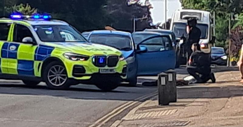 Dramatic scenes as armed police stop car and haul man out on rush hour street