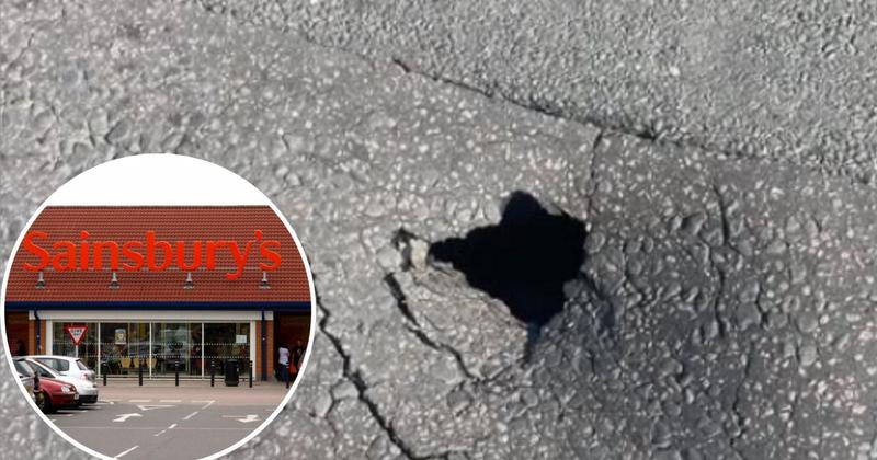 Sinkhole opens on road near supermarket