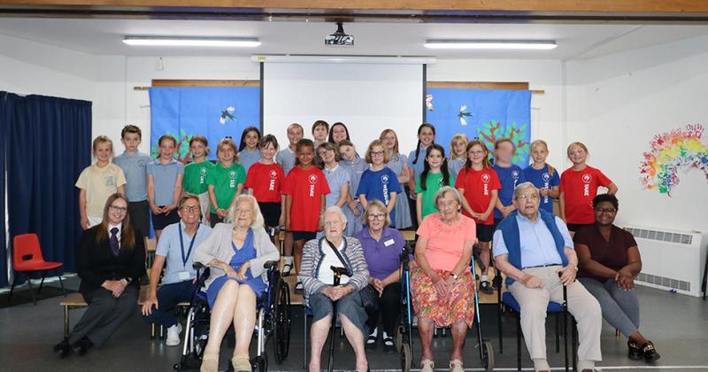 Care home residents treated to limo trip to primary school visit