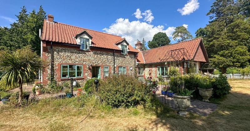 Brick and flint cottage in rural village for sale at £1 million guide