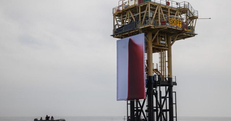 WATCH: Climate protestors climb gas platform and spray giant blood-red 'artwork'
