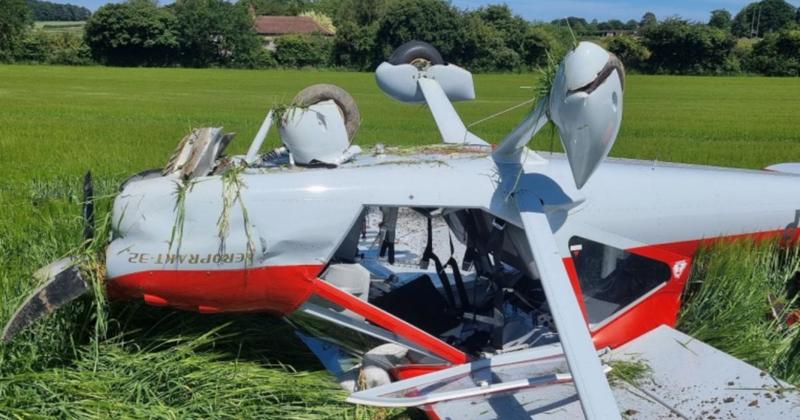 Plane flips upside down after crashing in corn field