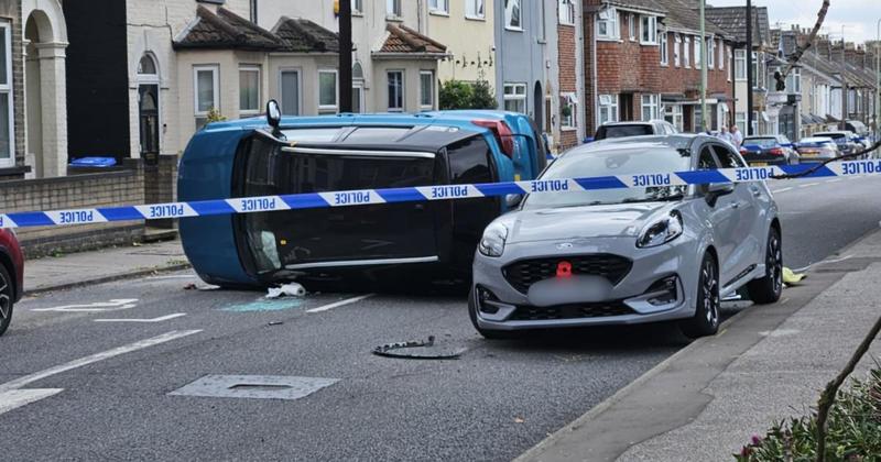 Two-vehicle crash leaves car on its side