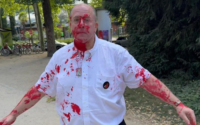 Activists shoved, attacked with red paint while hanging hostage posters in Frankfurt park