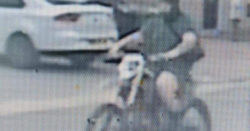 Balaclava-clad biker doing wheelies in wrong lane almost hits woman in her 70s
