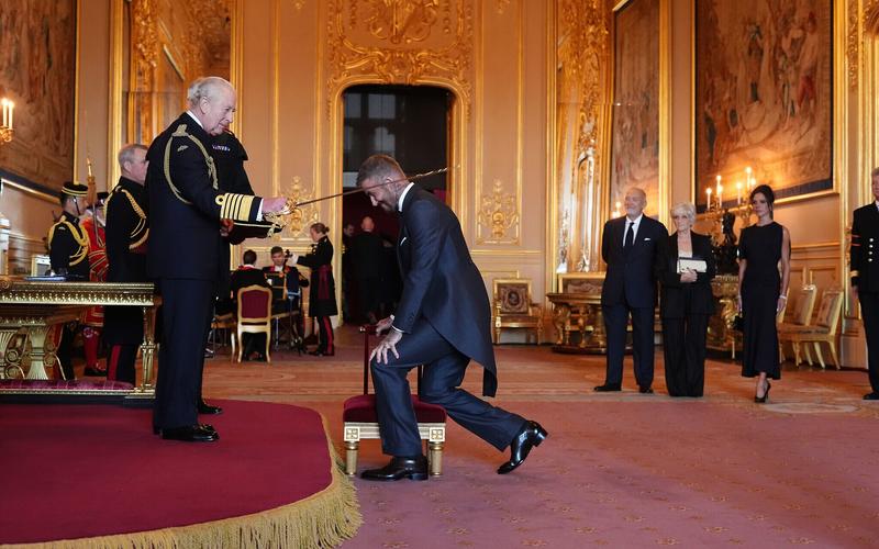 Bend a knee like Beckham: Soccer star is knighted by King Charles III