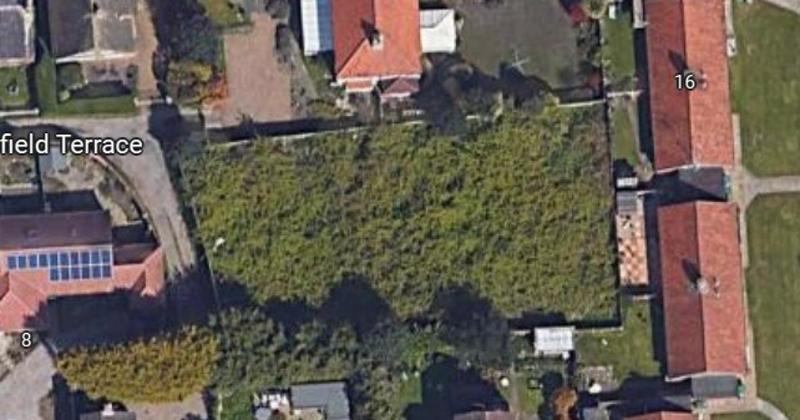 Housing bid for enclosed plot of land in seaside village