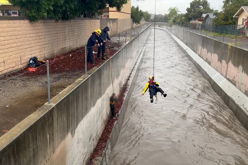 Man swept over a mile in raging floodwaters as storms batter California