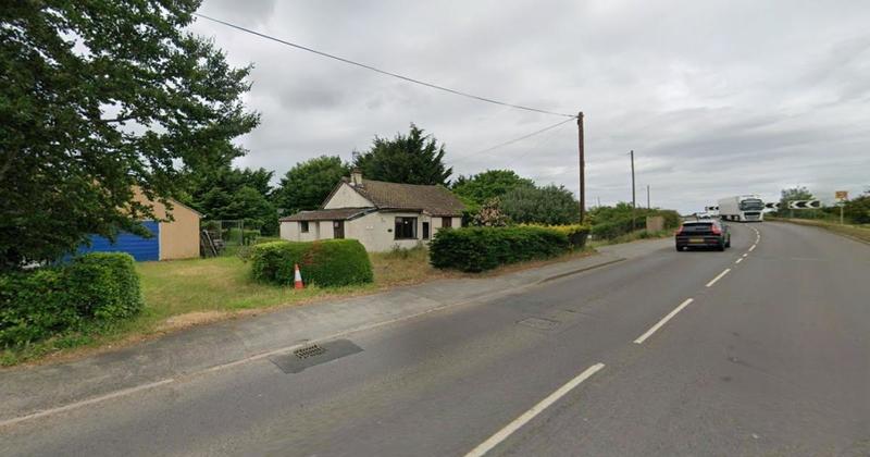 Plans for row of new homes next to busy road through village road thrown out