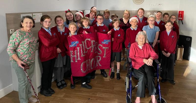 Schoolchildren bring festive cheer to care home residents