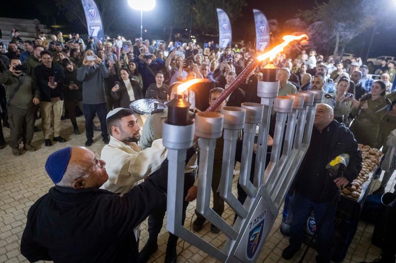 ‘Out of darkness’: Freed hostages lead Hanukkah candle-lightings