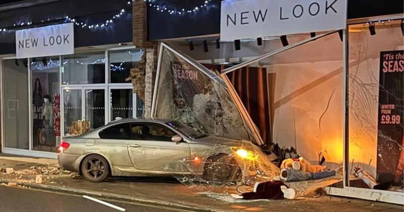 Driver on the run after BMW smashes into shop