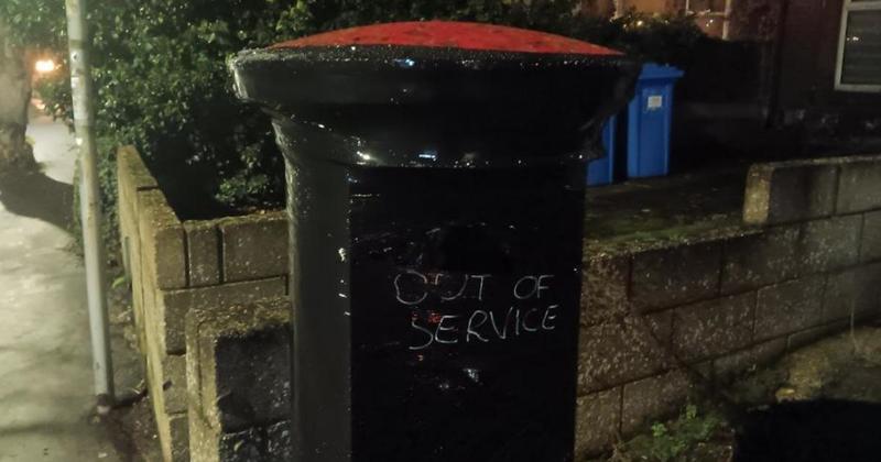 Post box in Golden Triangle covered by black bag before Christmas