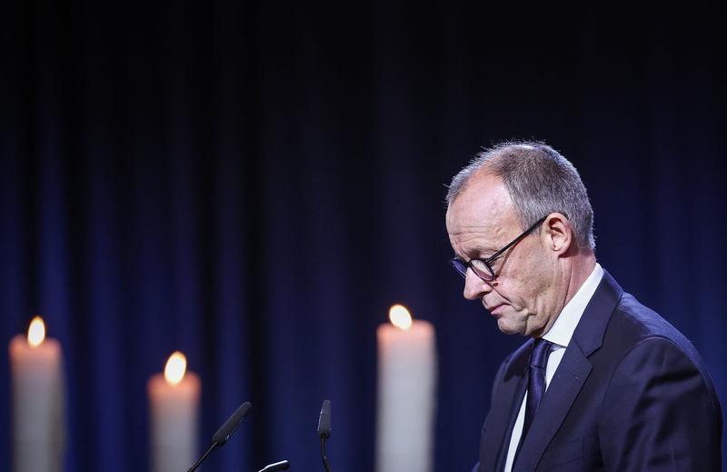 German chancellor urges ‘peaceful coexistence,’ a year after deadly market attack