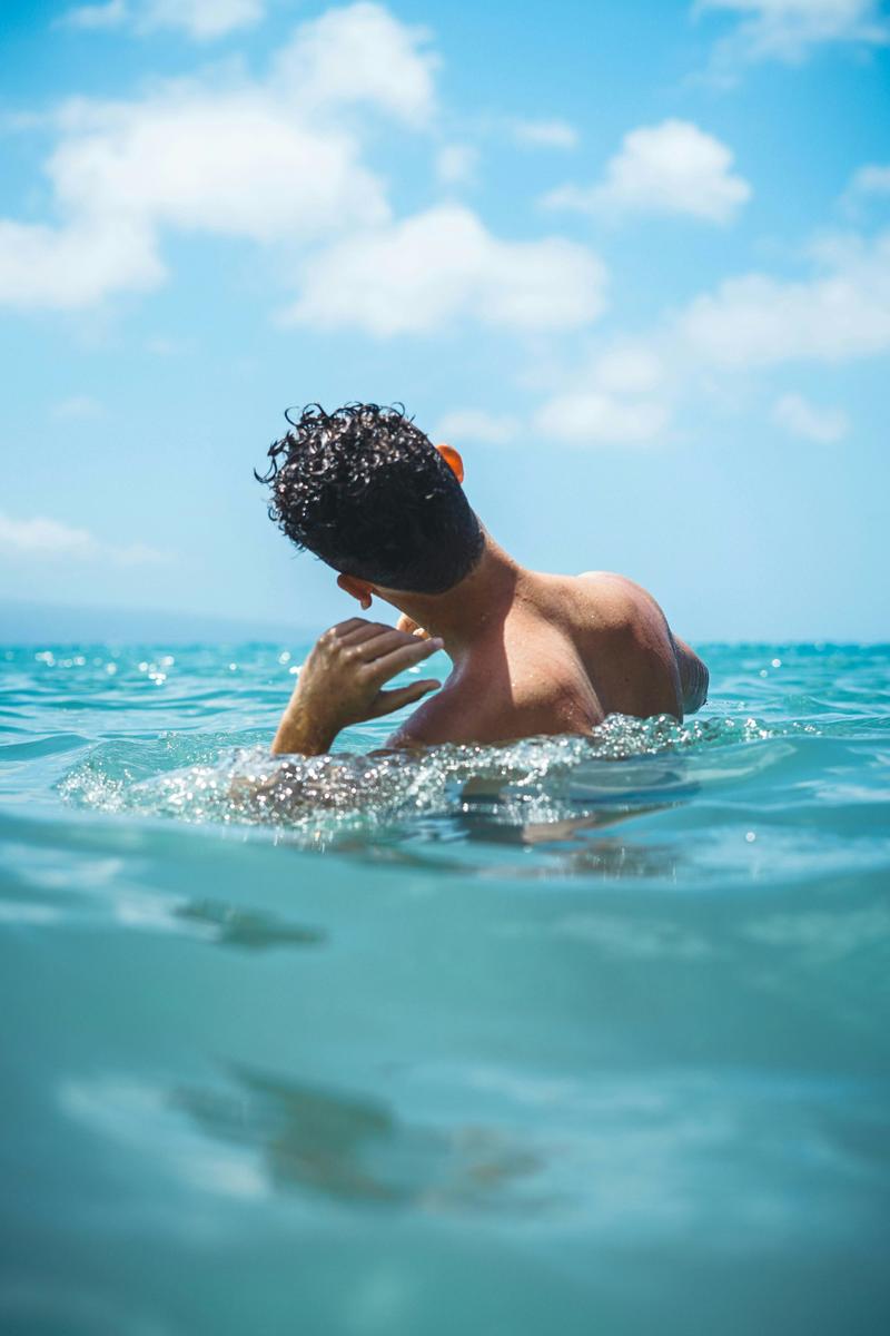 How can I get water out of my ear after swimming?